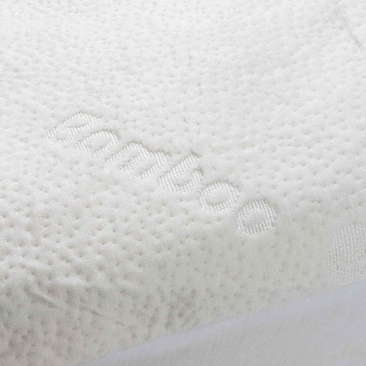 Close-up of a bamboo waterproof mattress protector with the word "bamboo" woven into the fabric.