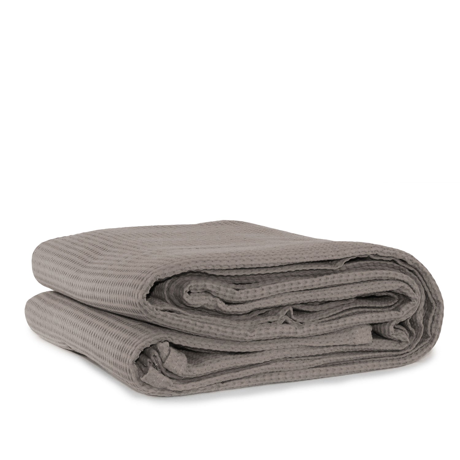 A folded latte cotton waffle blanket on a white background.
