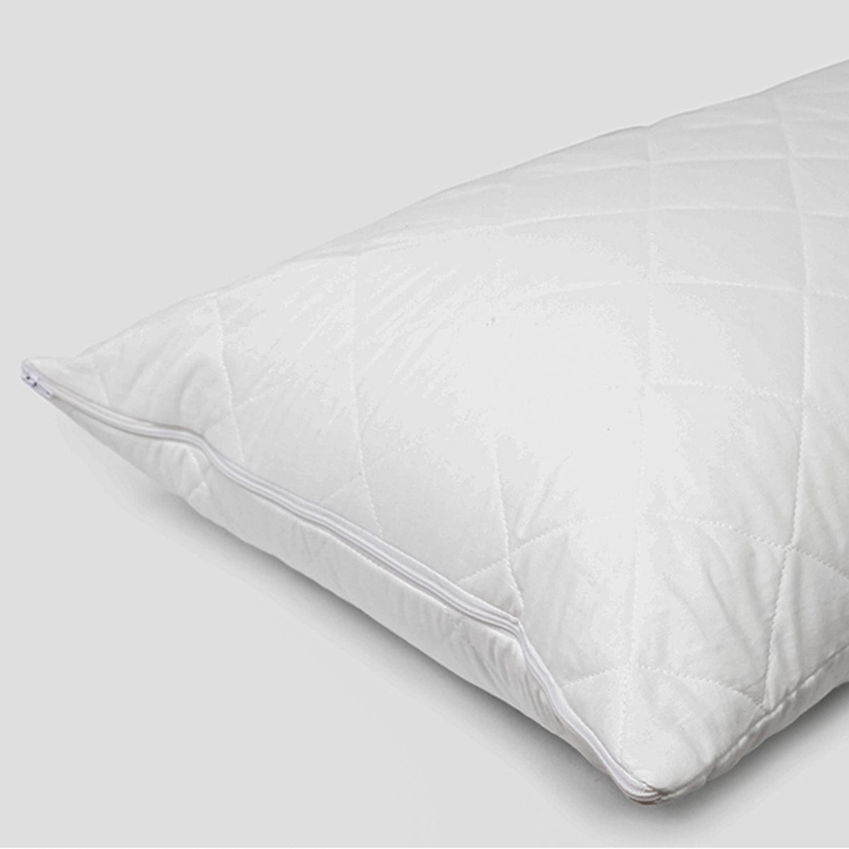 A white, Heavenly Dreams quilted cotton pillow protector with a zipper closure.