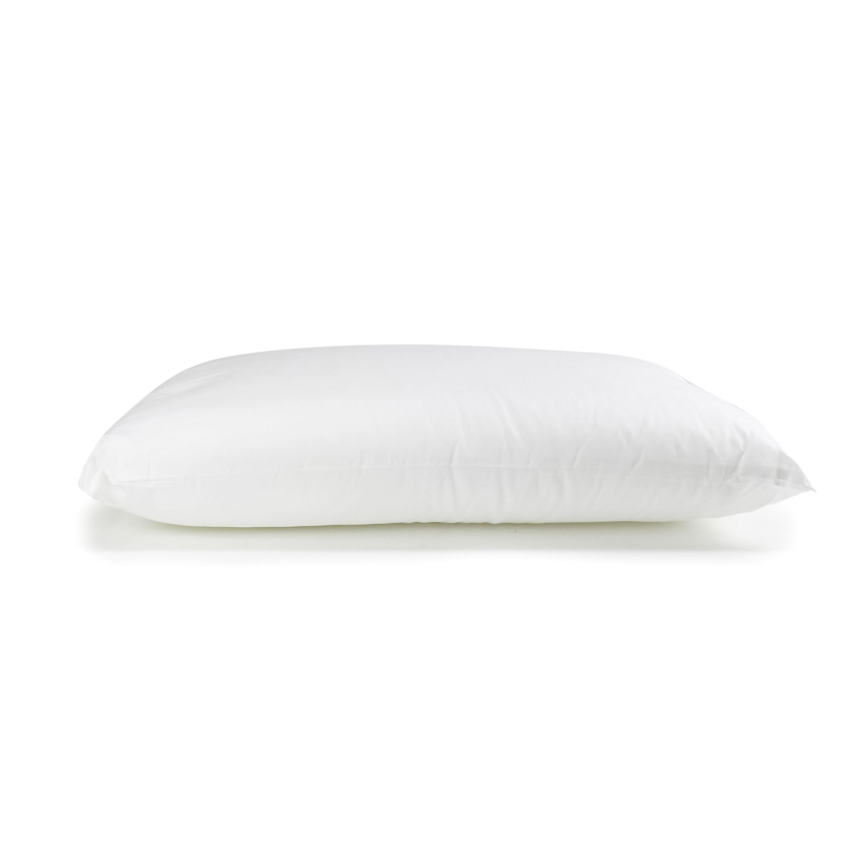 White J-Dream Loft pillow with a cotton Japara cover, shown in side profile on a white background.