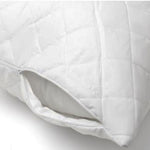 Close-up of a white J-Dream quilted pillow protector with a zipper partially opened, showing a pillow inside.
