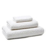 Stacked white terry towels in three sizes on a white background.