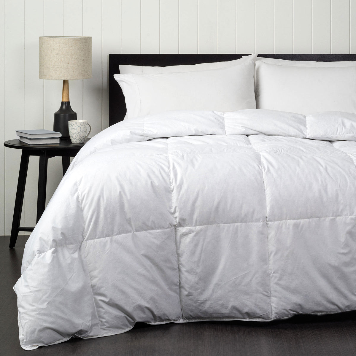 Luxurious white quilt with 70% duck down and 30% feather filling, styled on a neatly made bed.