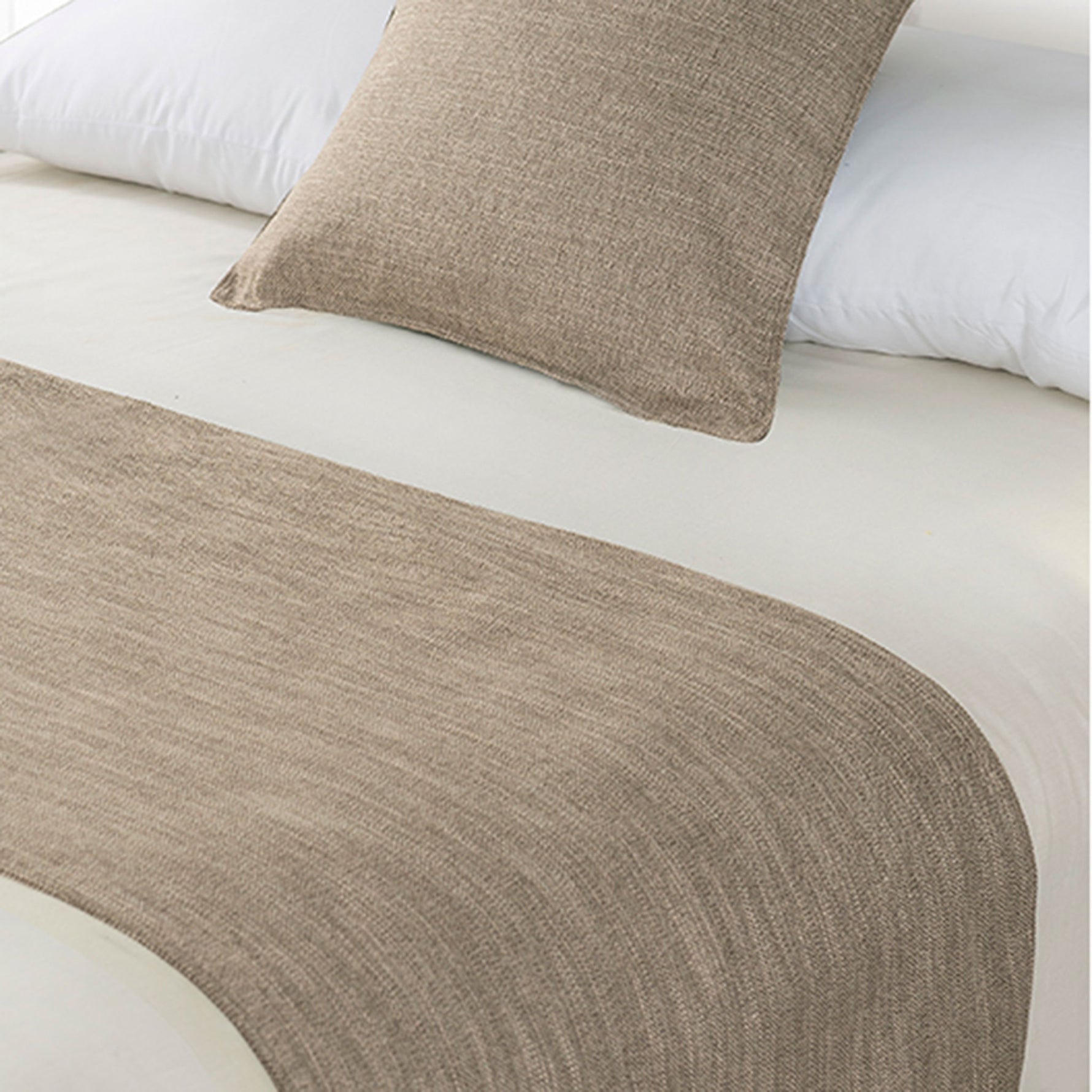 Sand beige linen-look bed runner and matching cushion displayed on a bed with white bedding.