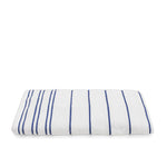 Folded white terry pool towel with ink blue horizontal pinstripes on a white background.
