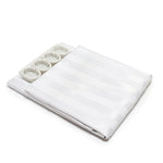 Folded white shower curtain with satin stripe pattern and shower rings on a white background.
