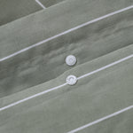 Close up of snap button closure on Studio Stripe quilt cover in sage