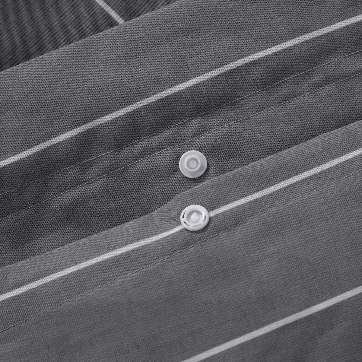 Close up of snap button closure on Studio Stripe quilt cover in slate